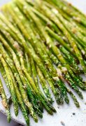 Vertical image of Air Fryer Asparagus on a plate/ Perfect Air Fryer Asparagus make a great side for any dish. Healthy, simple, and quick #airfryerasparagusrecipe #easyvegetableside #healthyairfryerasparagus #healthyasparagusrecipe