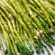Vertical image of Air Fryer Asparagus on a plate/ Perfect Air Fryer Asparagus make a great side for any dish. Healthy, simple, and quick #airfryerasparagusrecipe #easyvegetableside #healthyairfryerasparagus #healthyasparagusrecipe