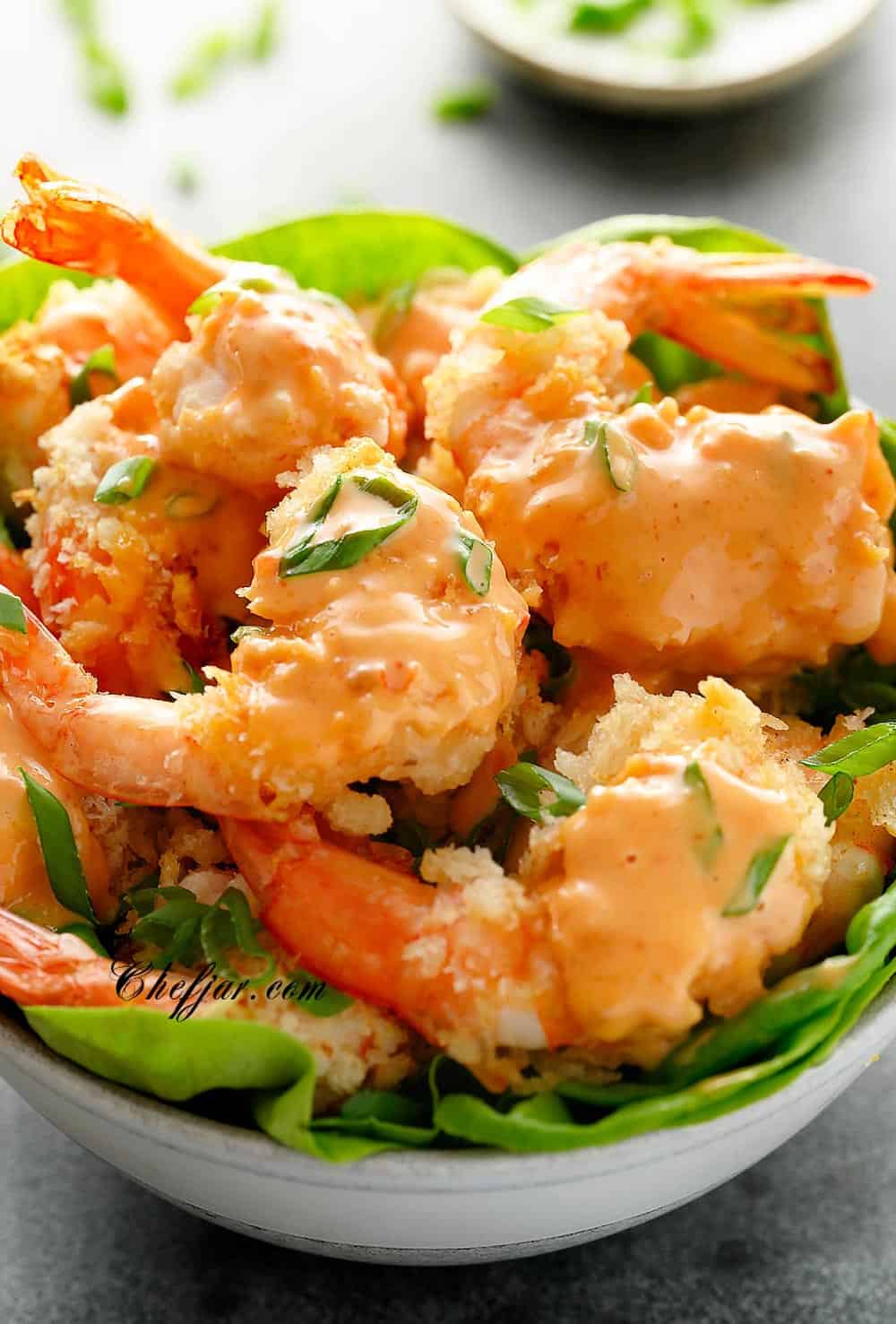 bang bang shrimp in a bowl with lettuce