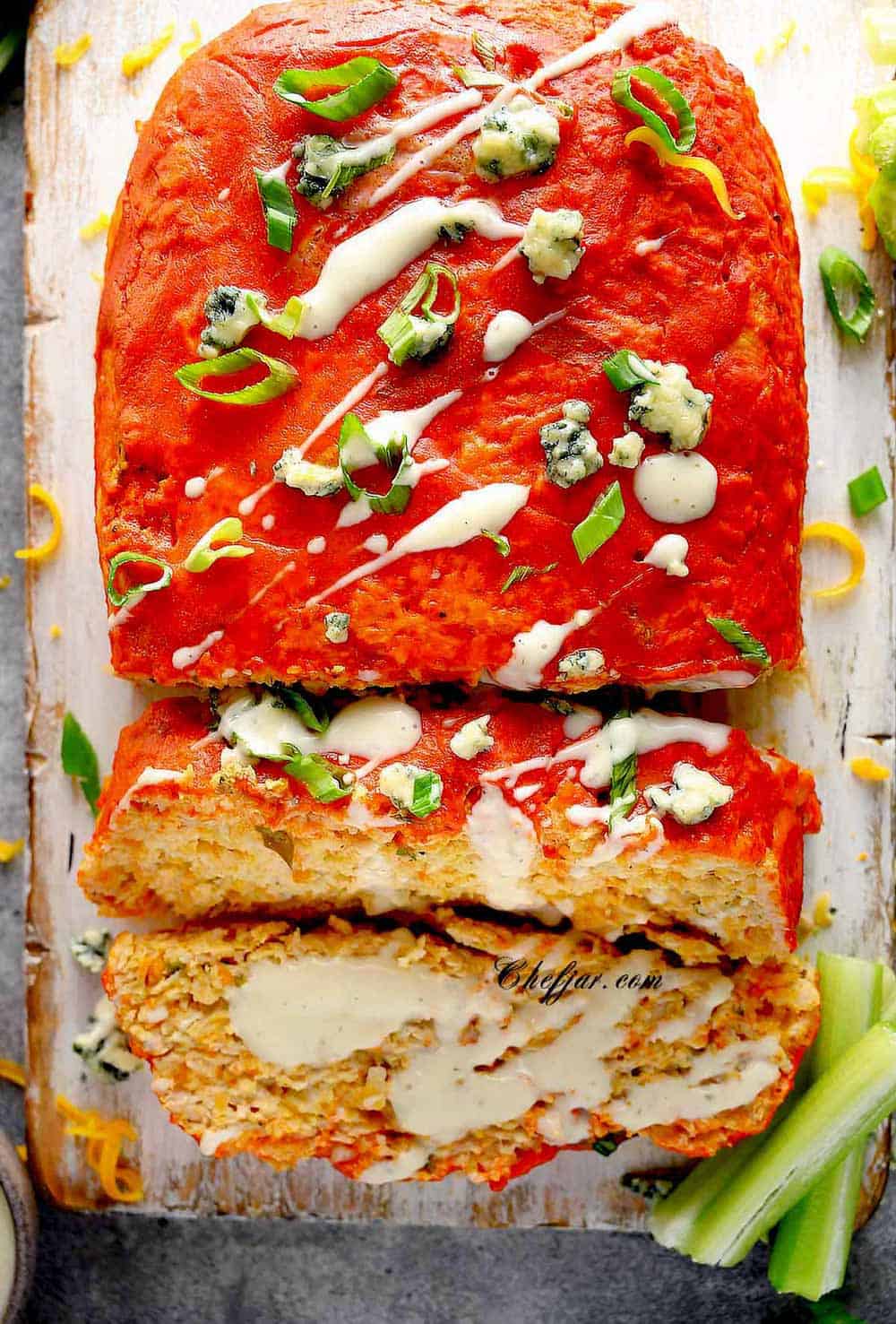 Buffalo Chicken Meatloaf on the cutting board with celery sticks
