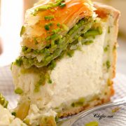 Creamy pistachio baklava cheesecake with a bite out of it / A rich, creamy, PERFECT Pistachio Baklava Cheesecake Recipe! Oh, and there's NO water bath required! #cheesecake #cheesecakerecipe #pistachiocheesecake