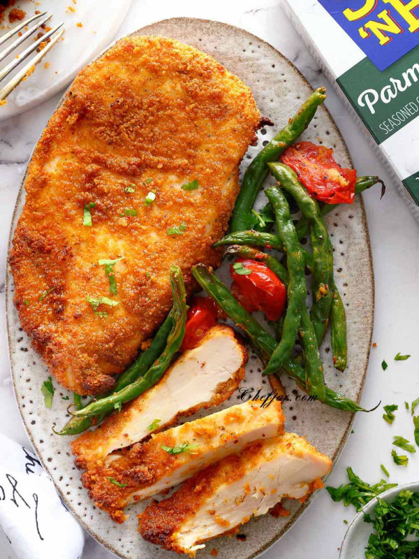 shake and bake chicken on the white ceramic plate/ Serve it with roasted green beans.