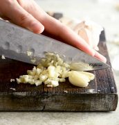 mincing garlic with large chef's knife