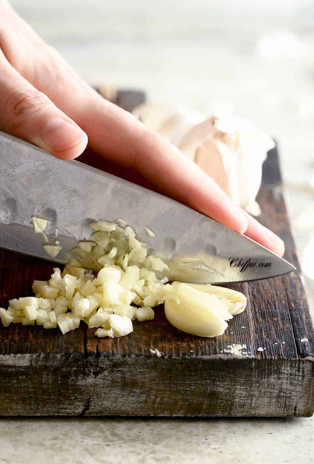 The photo shows how to cut garlic by finely mincing it