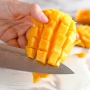 knife cutting mango cubes