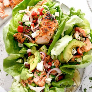 Mediterranean salmon lettuce wraps on a white plate