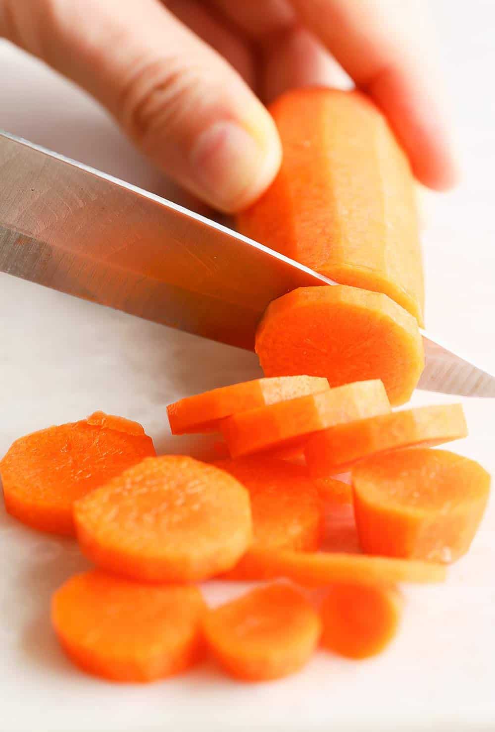 Hand cutting carrots into slices