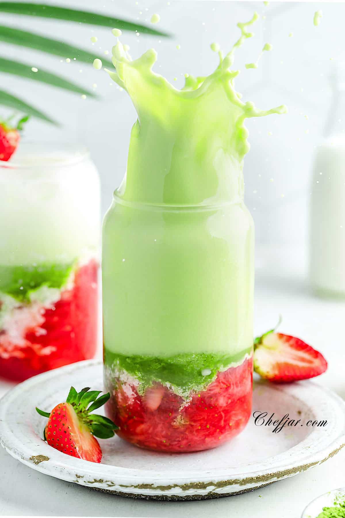Strawberry matcha latte with green, white, and red layers.