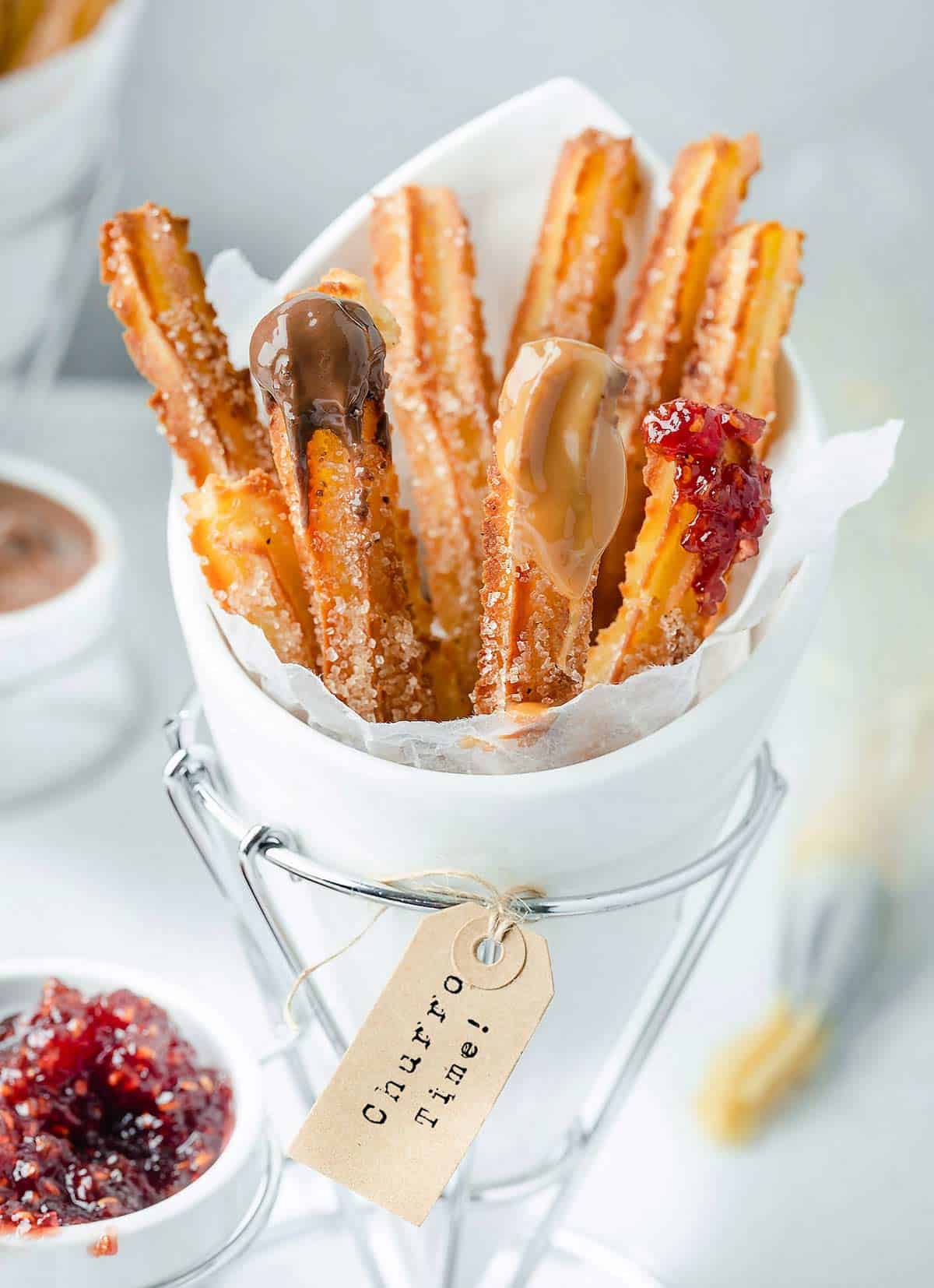 Air fryer churros in a white stand holder