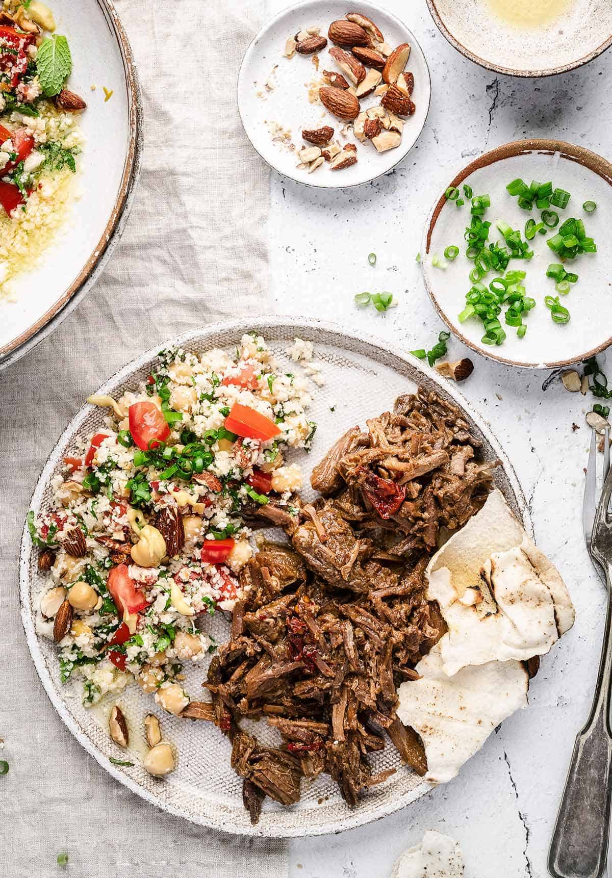 Cauliflower Tabbouleh Salad on a white plate, served with shredded beef