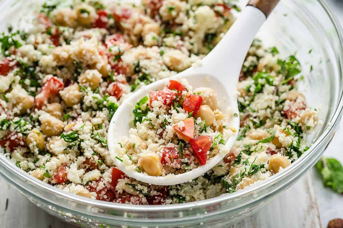Cauliflower Tabbouleh Salad in a large bowl with a spoon