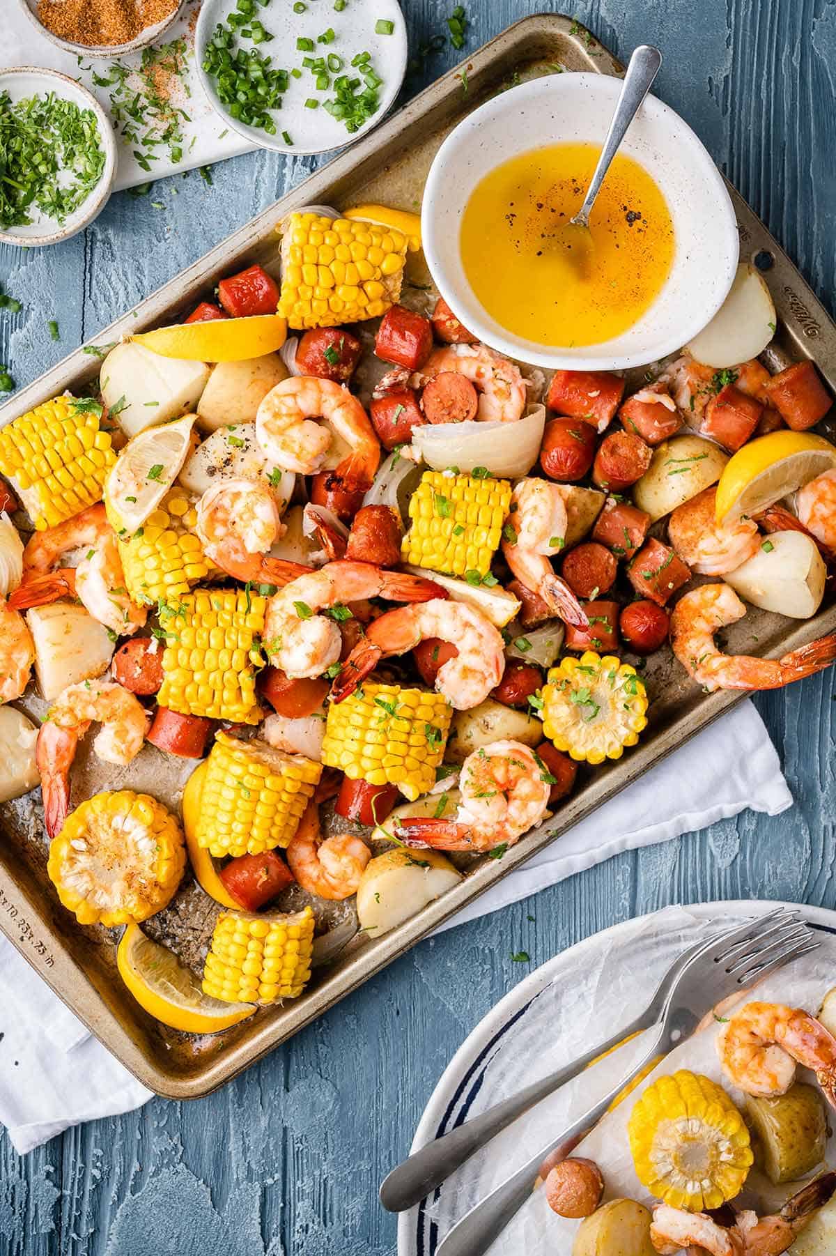 Shrimp Boil smothered in garlic butter and Creole seasoning made easy in the oven. Ready in 30 minutes!