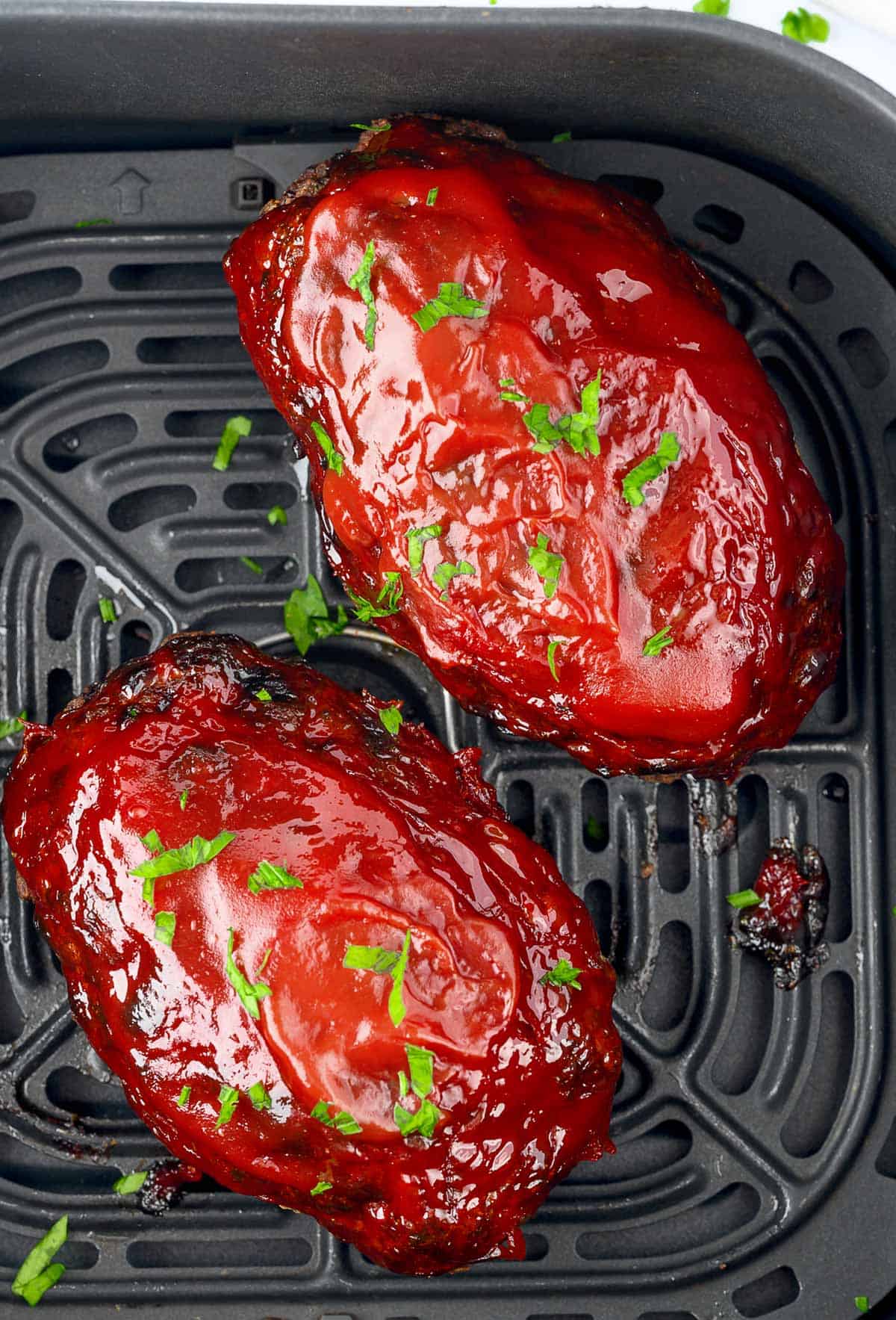 Two air fried meatloaves in the air fryer basket. #airfryermeatloaf #recipe #recipe #easy #airfryer #best #groundbeef