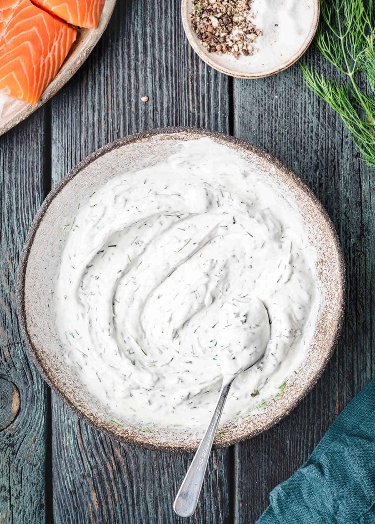 A bowl of creamy dill sauce for salmon 