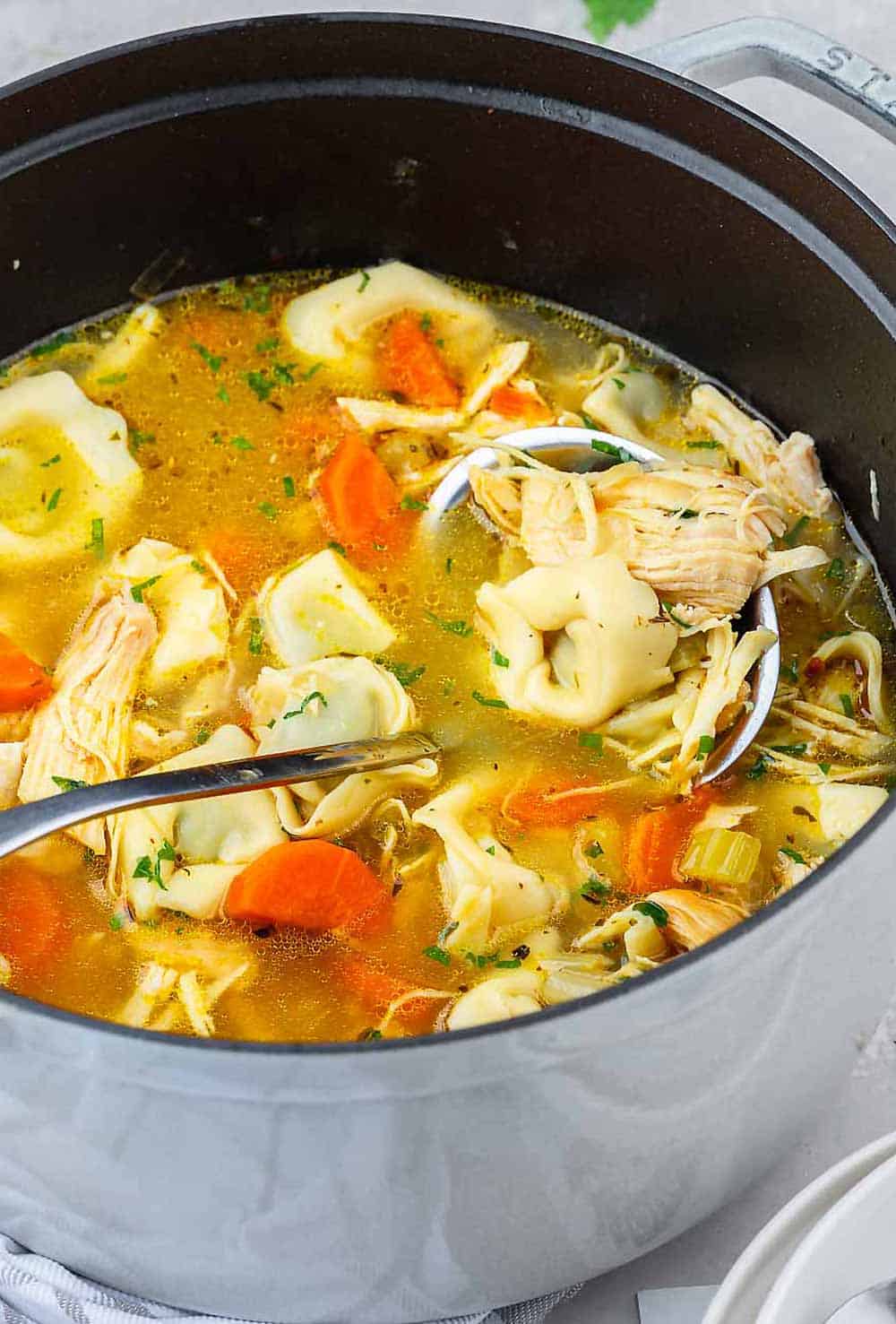 a bowl of chicken tortellini soup