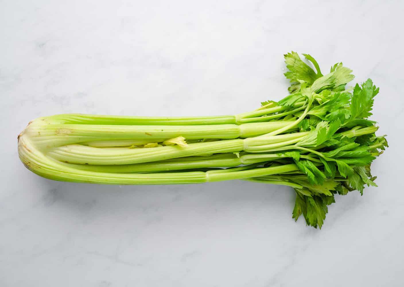 Celery stalk laying flat on working surface.
