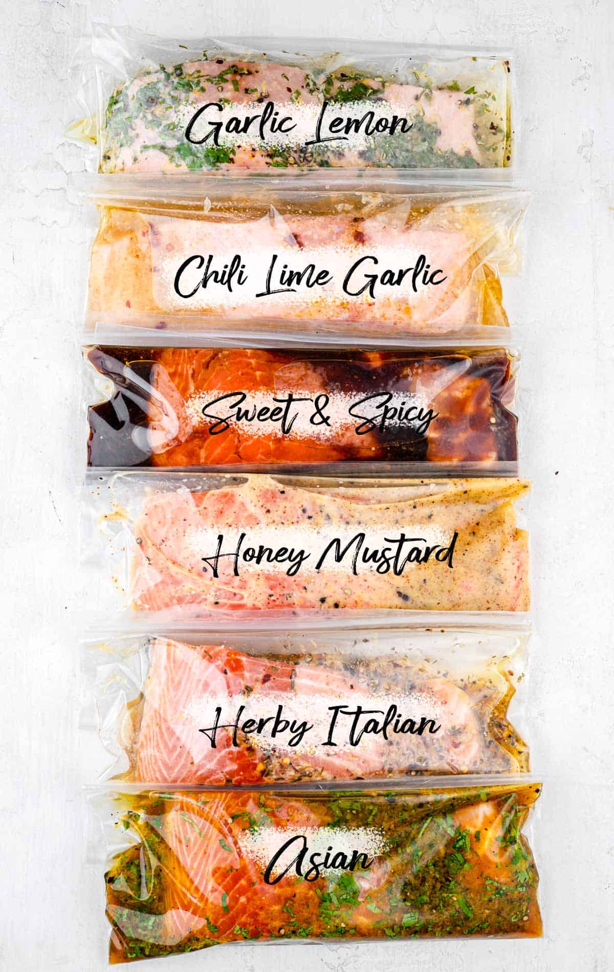 six salmon marinades in plastic bags stacked beside each other 