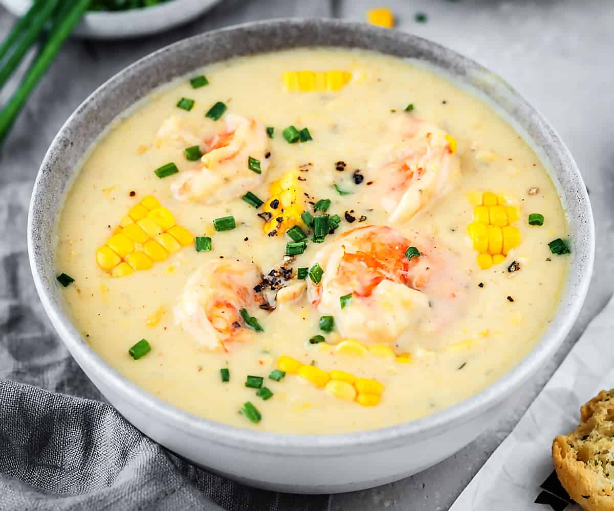 Creamy shrimp and corn soup in a ceramic grey bowl