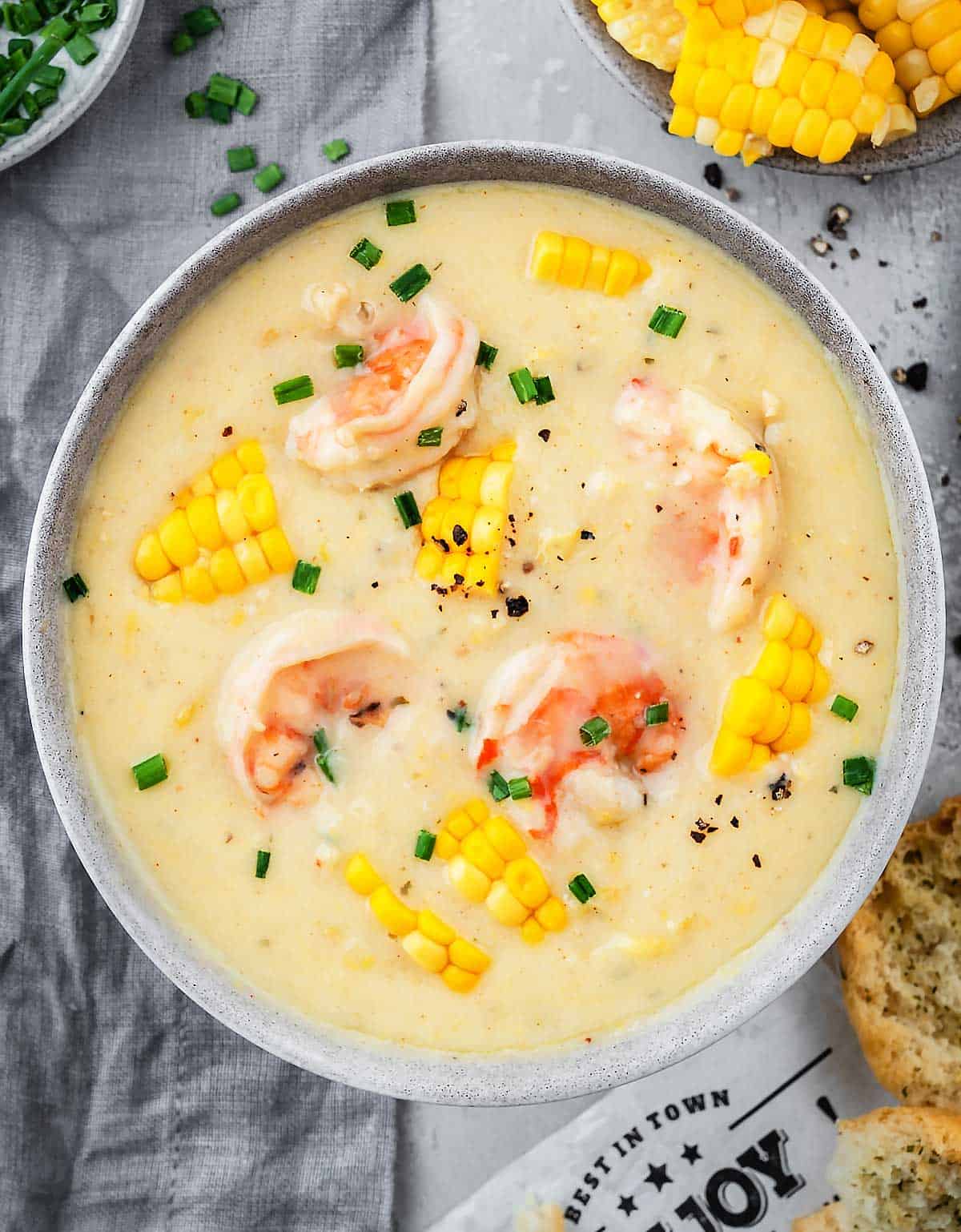 A bowl with shrimp and corn soup