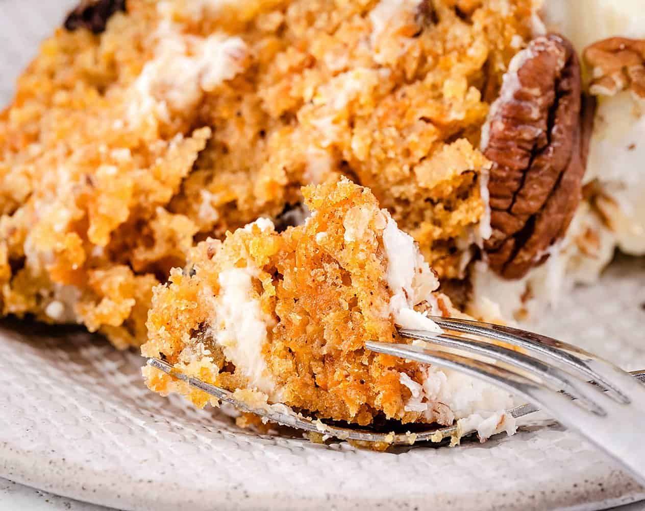 A piece of carrot cake on the fork.