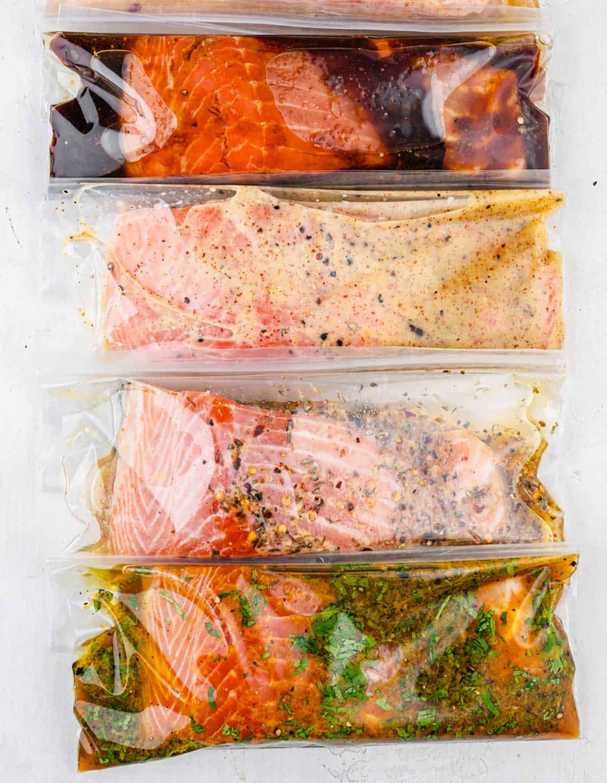 Salmon fillets in plastic bags with marinade