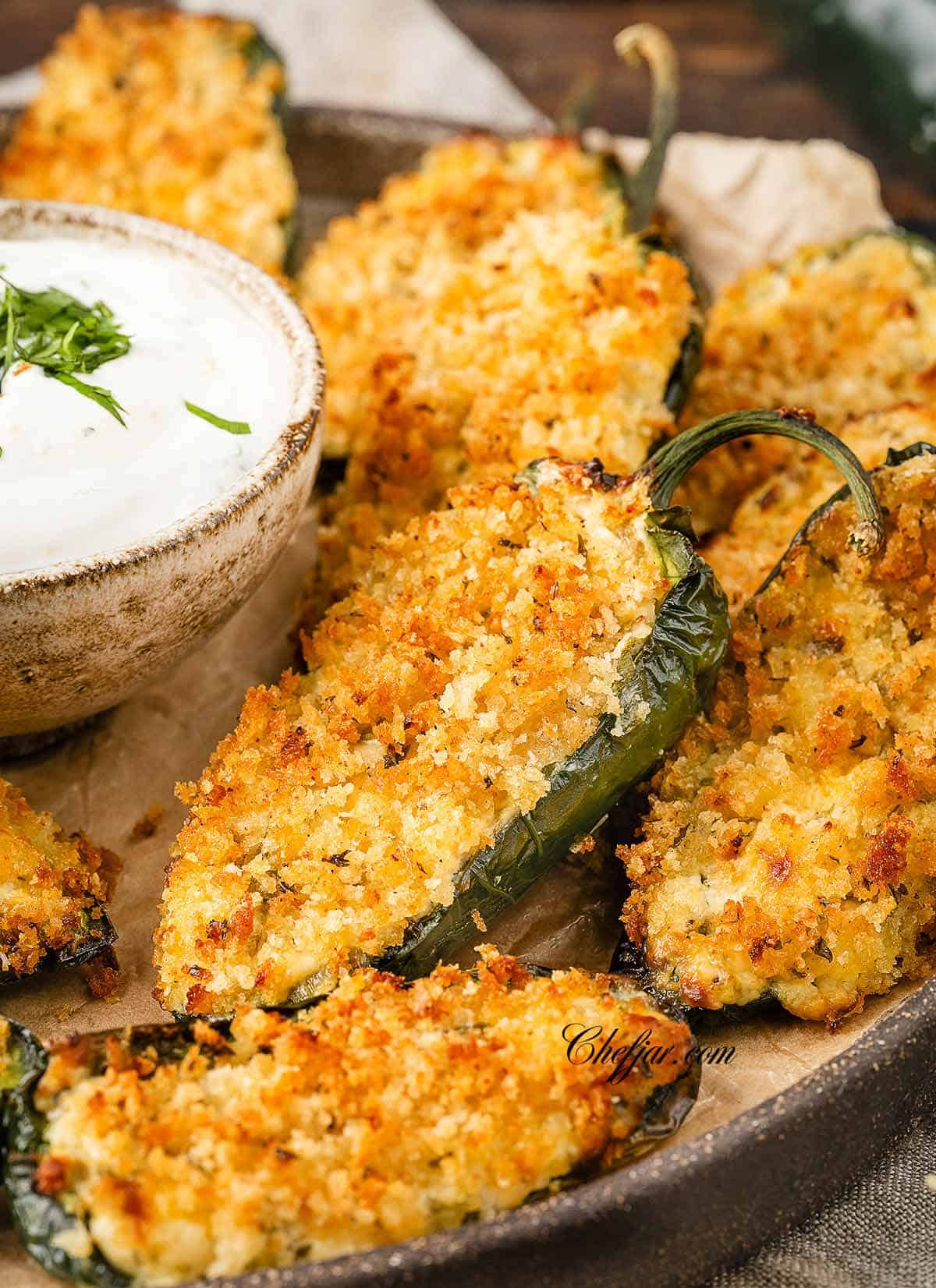 A close up image of Jalapeno Poppers with crispy panko on top.