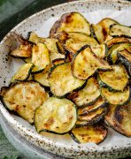 Air fryer zucchini chips on a plate.