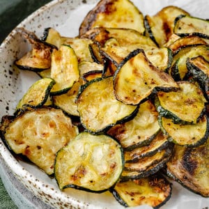 Air fryer zucchini chips on a plate.