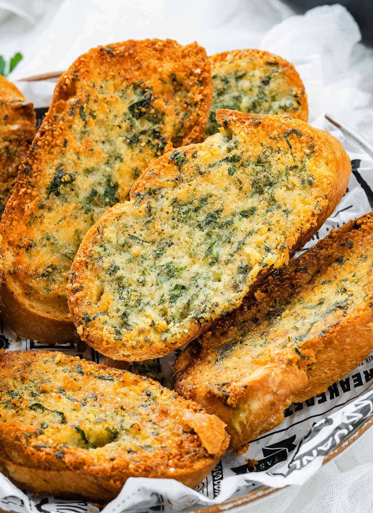 Close up of a stack of garlic bread on a plate.