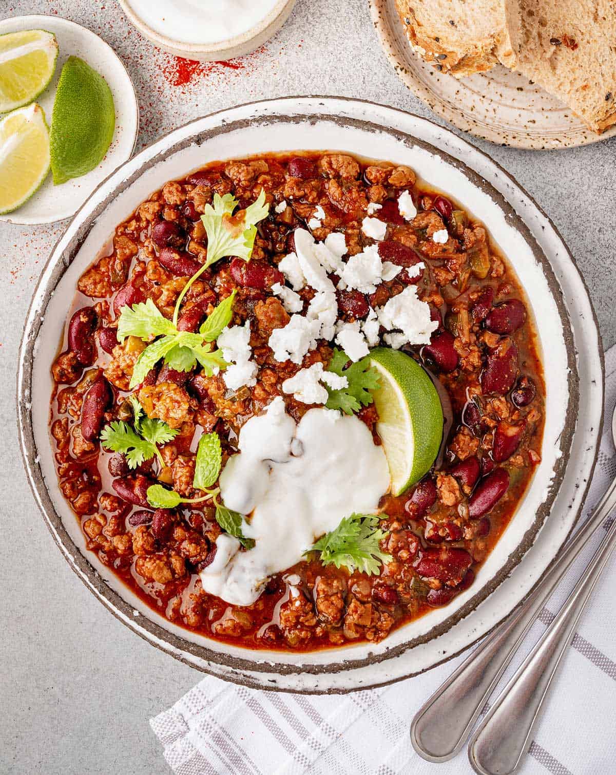 A bowl of homemade lamb chili with plenty of toppings.