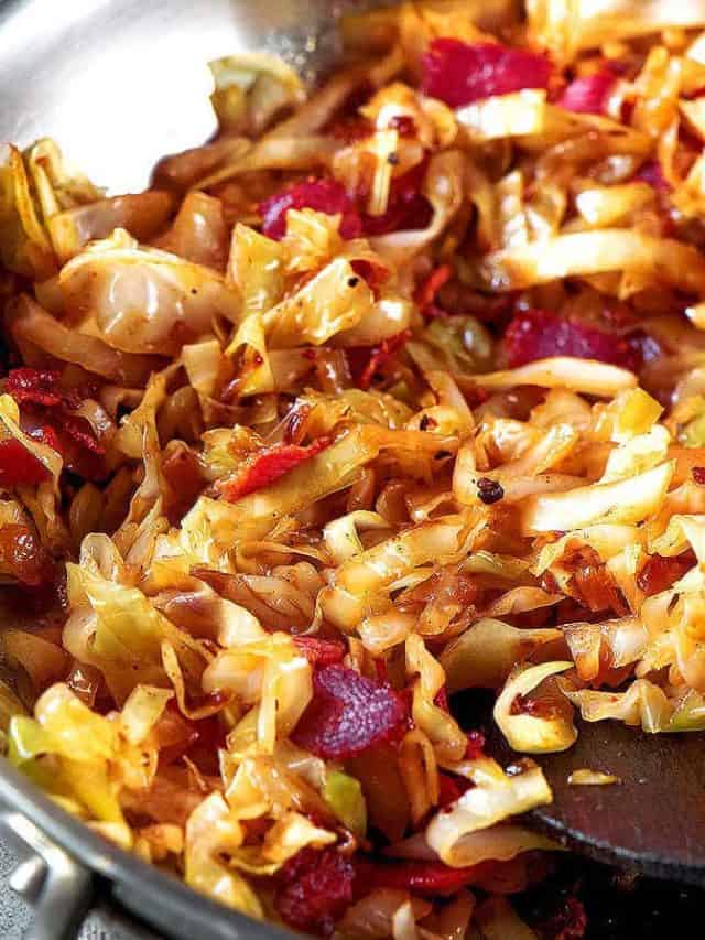 Fried cabbage in a skillet.