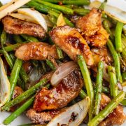 Copycat version of Panda Express String Bean Chicken, a Chinese-American dish, served in a white bowl with green beans, chicken pieces, and a flavorful brown sauce.