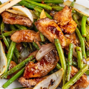 Copycat version of Panda Express String Bean Chicken, a Chinese-American dish, served in a white bowl with green beans, chicken pieces, and a flavorful brown sauce.