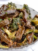Panda Express Broccoli Beef in a white bowl: Stir-fried beef and broccoli dish with a flavorful sauce.