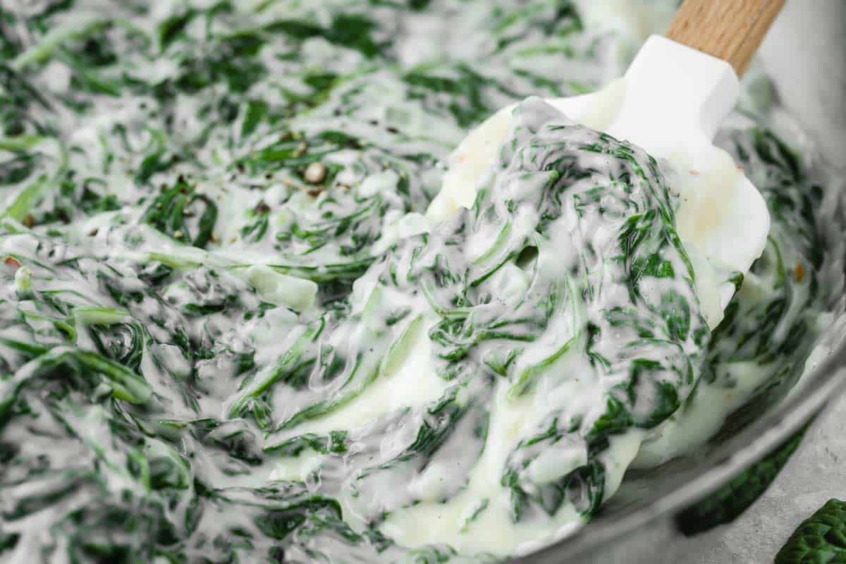 Steakhouse creamed spinach prepared in a large skillet.