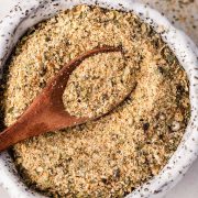 Homemade all-purpose seasoning in a small bowl with a wooden spice spoon.