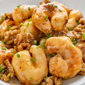 Honey Walnut Shrimp in a white serving bowl, garnished with green onions