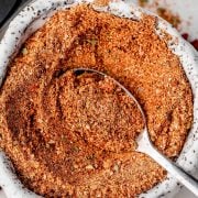 Image of Homemade Sazon Seasoning in a small bowl with a spoon.