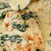 Pouring Boursin cheese sauce over Creamy Boursin Chicken in a skillet.