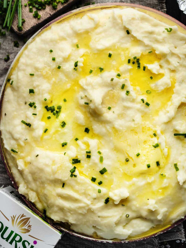 Overhead shot of creamy mashed potatoes with chives.