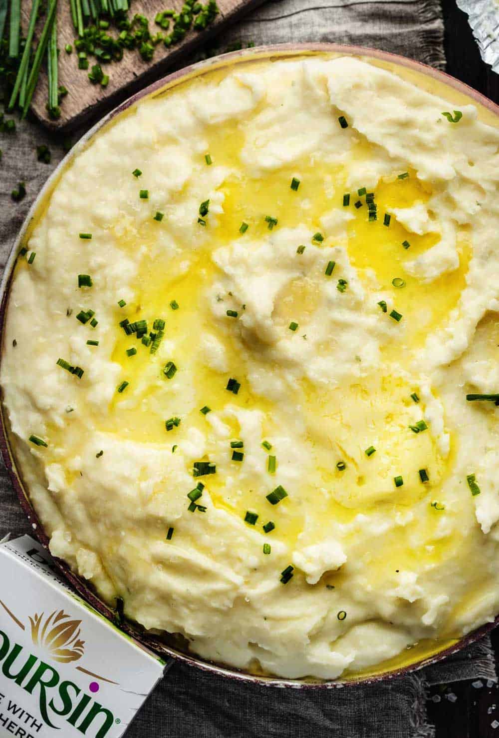 Overhead shot of creamy mashed potatoes with chives.