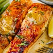 A close-up view of Cajun Honey Butter Salmon, adorned with a delectable spoonful of Cajun Honey Butter on top.