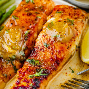A close-up view of Cajun Honey Butter Salmon, adorned with a delectable spoonful of Cajun Honey Butter on top.