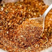 Homemade Cajun Seasoning in a small bowl with a spoon.