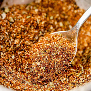 Homemade Cajun Seasoning in a small bowl with a spoon.