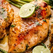 Close-up of golden-baked Sheet Pan Miso Honey Chicken and Asparagus. Juicy chicken, roasted asparagus, and flavorful sauce.