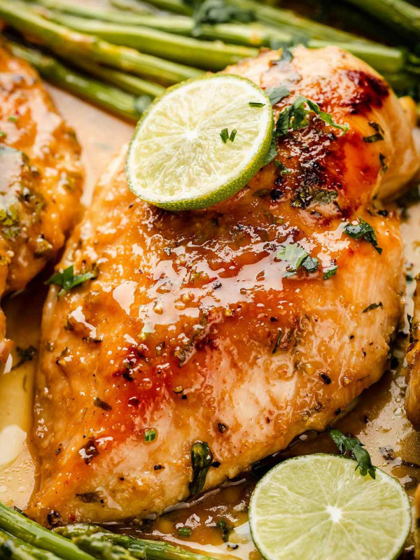 Close-up of golden-baked Sheet Pan Miso Honey Chicken and Asparagus. Juicy chicken, roasted asparagus, and flavorful sauce.