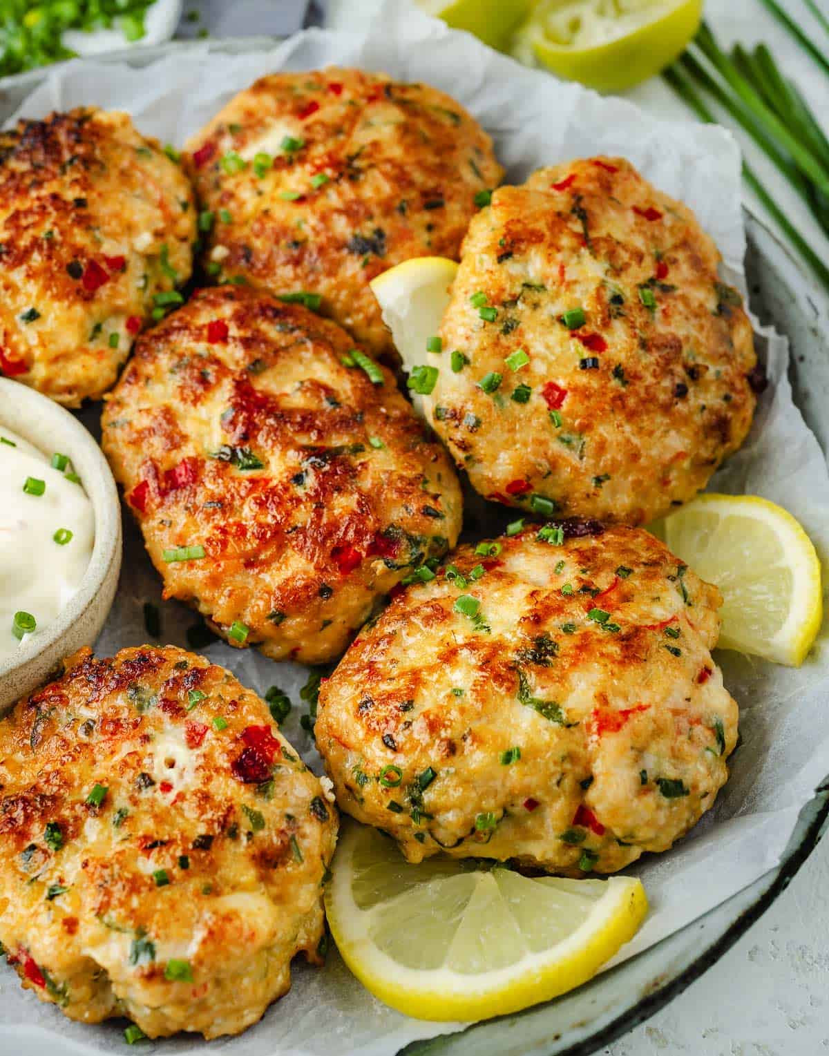 Delicious shrimp cakes plated with lemon slices.