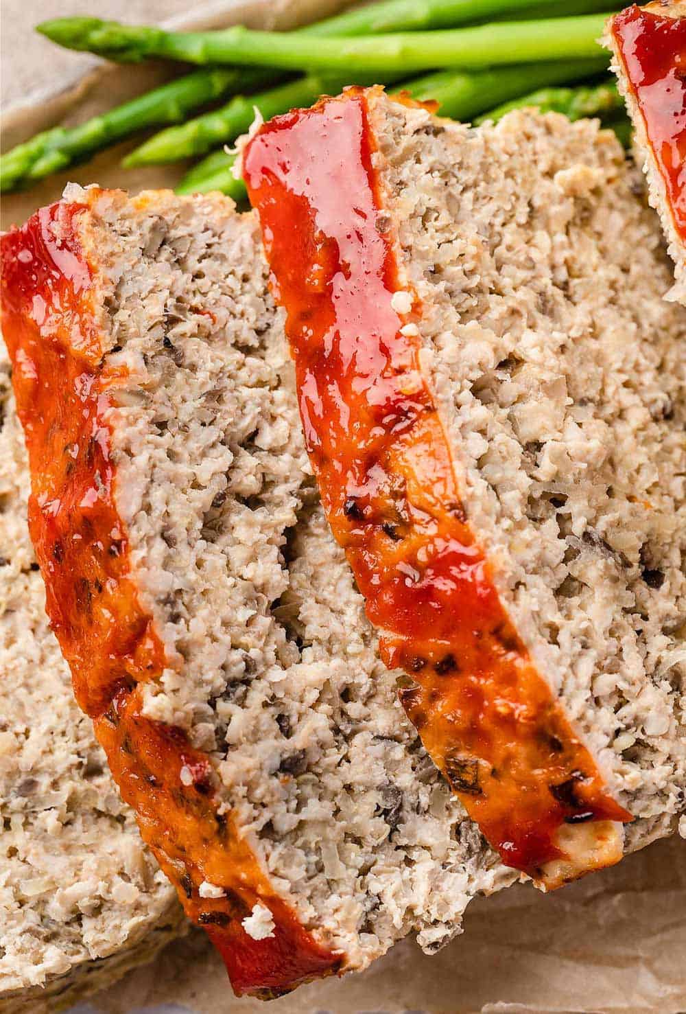 Close-up view of slices of Turkey Quinoa Meatloaf, showcasing its hearty texture and wholesome ingredients.