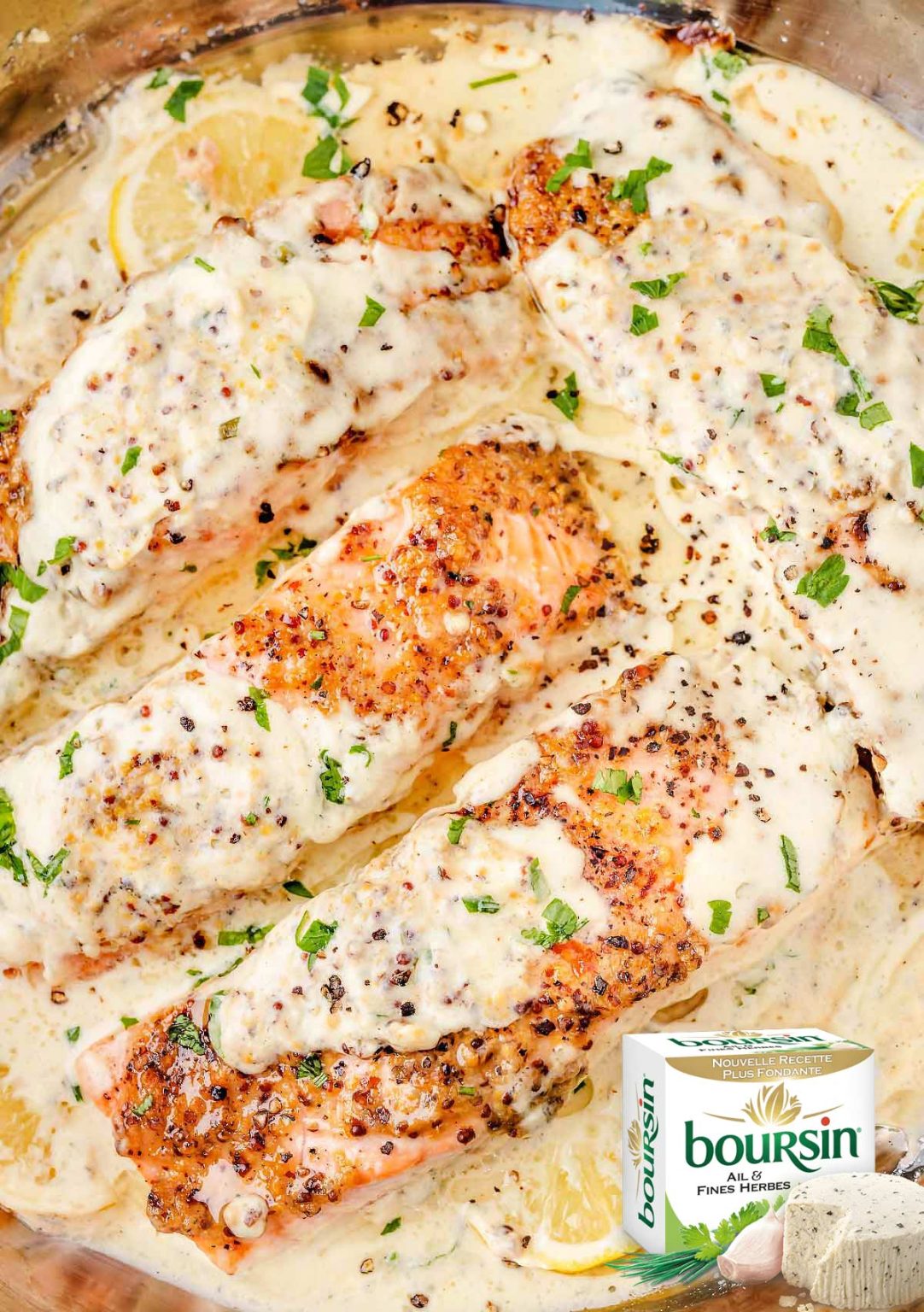 Overhead view of succulent Boursin salmon fillets in a creamy skillet sauce.